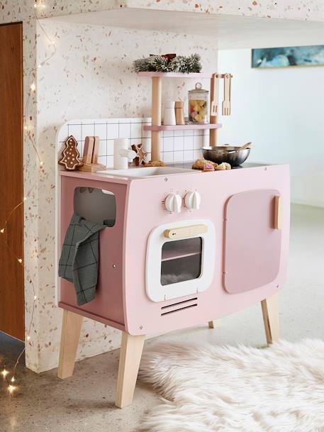 pink wooden kitchen with washing machine